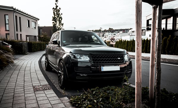 Black Range Rover in affluent neighborhood